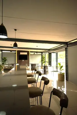 a dining room with chairs and a table in a building at The Anza Lifestyle Lodge in Louis Trichardt