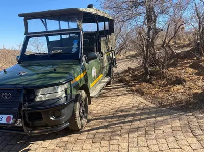 a green jeep parked on a dirt road at Reedbuck Lodge @Cyferfontein in Mabalingwe Reserve in Bela-Bela