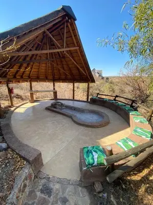 a patio with a pavilion with a swimming pool at Reedbuck Lodge @Cyferfontein in Mabalingwe Reserve in Bela-Bela