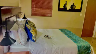 a bedroom with a white bed and a lamp at Lemba Lodge in Dwarsrivier