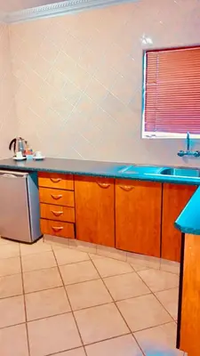 a kitchen with a counter and a sink and a window at Lemba Lodge in Dwarsrivier