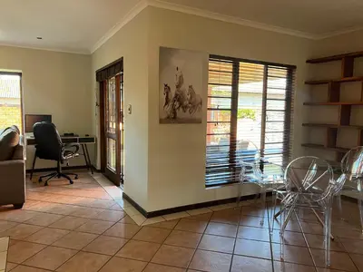 a living room with a table and chairs at Centurion Ambient Townhouse in Centurion