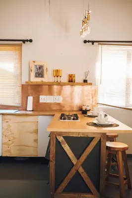a kitchen with a wooden island with a counter top at Arched Farmstead in Eerstegoud