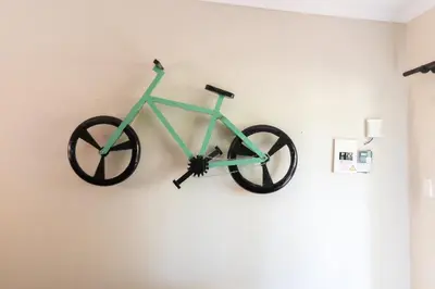 a green bike hanging on a wall in a room at Arched Farmstead in Eerstegoud