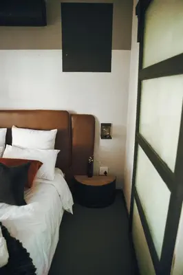 a hotel room with a bed with white pillows at Arched Farmstead in Eerstegoud