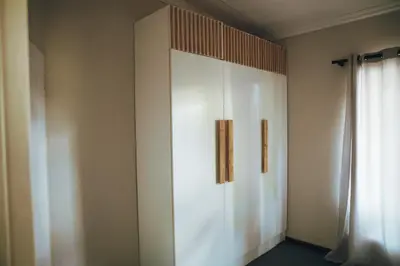 a white cabinet in a room with a window at Arched Farmstead in Eerstegoud