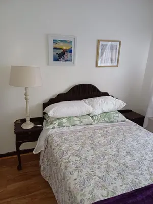 a bedroom with a bed and a table with a lamp at @336 Bourke in Pretoria