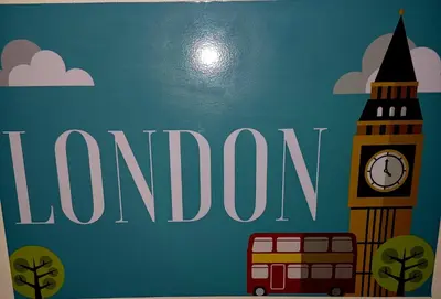 a sign for london with a bus and big ben at @336 Bourke in Pretoria
