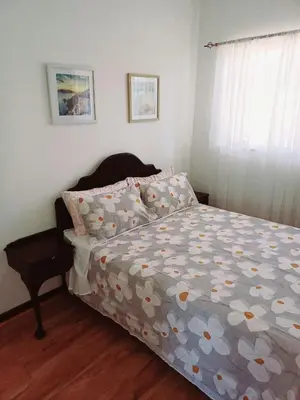 a bedroom with a bed with a comforter on it at @336 Bourke in Pretoria