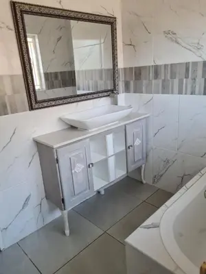 a bathroom with a sink and a mirror and a tub at @336 Bourke in Pretoria