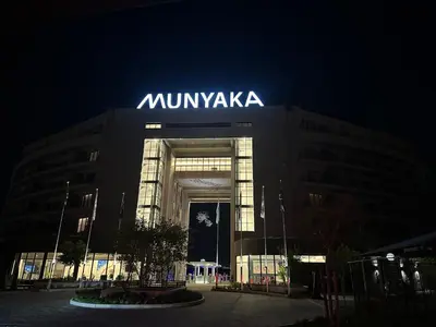a large building with a sign on it at night at Cosy Waterfall Midrand Apartment in Midrand