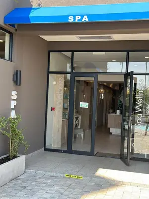 a store with sliding glass doors in a building at Cosy Waterfall Midrand Apartment in Midrand