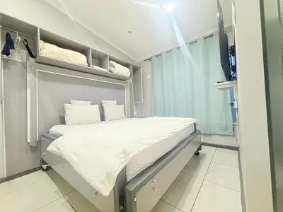 a hospital room with a bed and a tv at Silent Night Guest House Sunnyside Pretoria in Pretoria