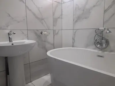 a white bathroom with a sink and a bath tub at Silent Night Guest House Sunnyside Pretoria in Pretoria