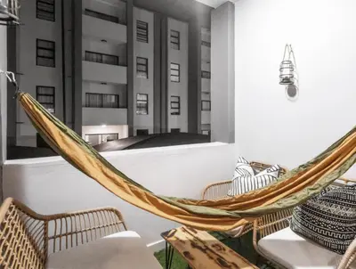 a hammock in a room with buildings at Midrand Classy & Eclectic 1-Bed w/Throwback Vibes in Midrand