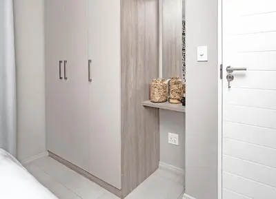 a glass door in a bedroom with a shelf at Midrand Classy & Eclectic 1-Bed w/Throwback Vibes in Midrand