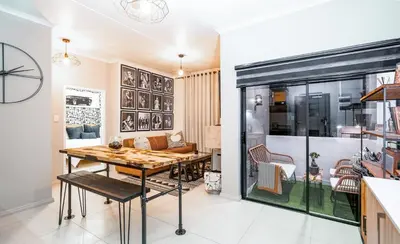 a dining room with a table and a couch at Midrand Classy & Eclectic 1-Bed w/Throwback Vibes in Midrand