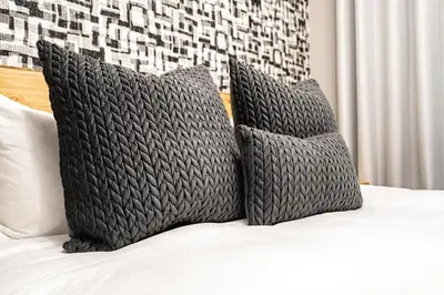 a bed with two pillows on top of it at Midrand Classy & Eclectic 1-Bed w/Throwback Vibes in Midrand