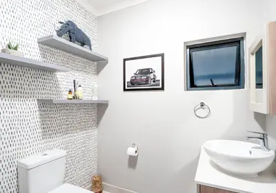 a white bathroom with a sink and a toilet at Midrand Classy & Eclectic 1-Bed w/Throwback Vibes in Midrand