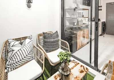 a room with wicker chairs and a table at Midrand Classy & Eclectic 1-Bed w/Throwback Vibes in Midrand