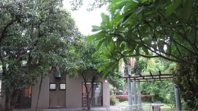 a building with trees in front of it at Parksig Self Catering in Musina