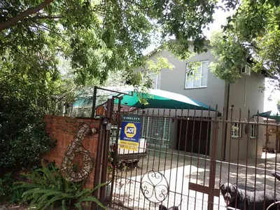 a wrought iron fence in front of a house at Edwil's Place in Hartbeespoort