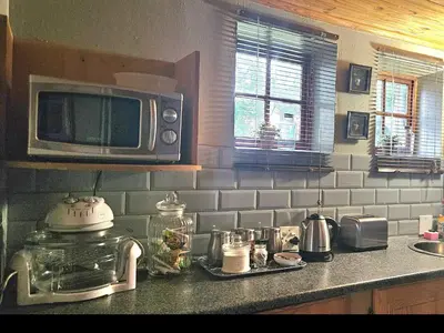 a kitchen with a microwave and a counter top at Grobler's Haven Self catering cottage in Pretoria