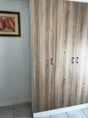 a wooden cabinet in the corner of a room at @Bevuzu Creek apartment in Pretoria