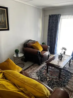 a living room with a couch and a table at @Bevuzu Creek apartment in Pretoria