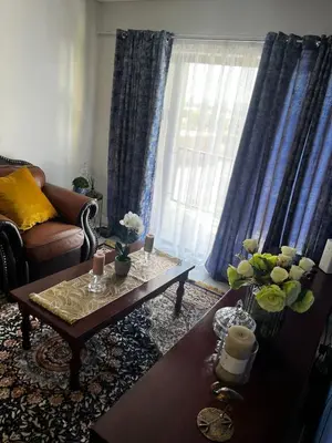 a living room with a couch and a coffee table at @Bevuzu Creek apartment in Pretoria