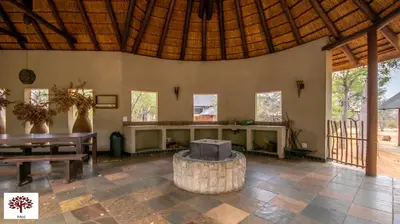 a living room with a table and a bench at Zebula Golf and Wildlife Estate - The Milky Way Pax 12 - Moi Signature Luxury villa in Mabula