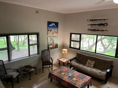 a living room with a couch and a table at Blyde River Self-Catering Studios in Hoedspruit