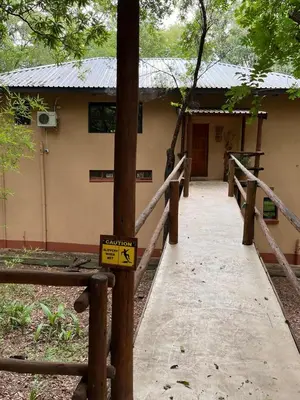 a walkway leading to a building with a sign on it at Blyde River Self-Catering Studios in Hoedspruit