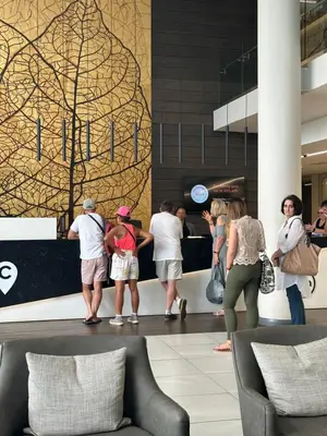 a group of people standing around in a lobby at The Capital Trilogy Menlyn Maine Apartments 913 in Pretoria