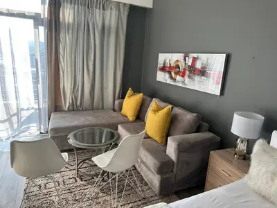 a living room with a couch and a table at The Capital Trilogy Menlyn Maine Apartments 913 in Pretoria