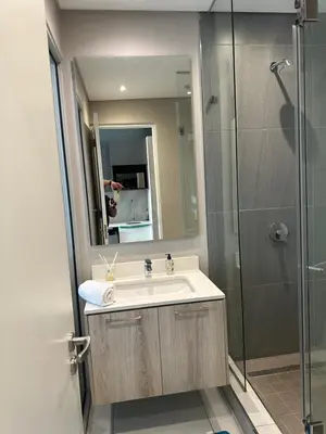 a bathroom with a sink and a shower at The Capital Trilogy Menlyn Maine Apartments 913 in Pretoria