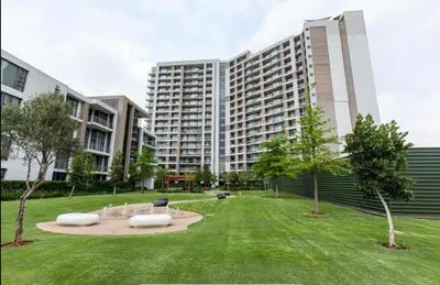 a park in front of a large building at The Capital Trilogy Menlyn Maine Apartments 913 in Pretoria