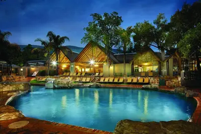 a large swimming pool in front of a house at First Group Magalies Park in Hartbeespoort