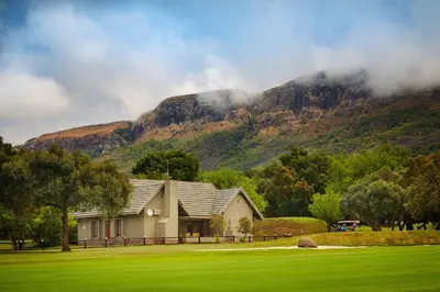 a house with a mountain in the background at First Group Magalies Park in Hartbeespoort