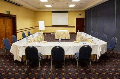 a conference room with a large table and chairs at First Group Magalies Park in Hartbeespoort