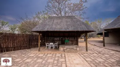 a gazebo with two chairs and a table at Zebula Golf and Wildlife Estate - Jackals Call Pax 8 - Moi Signature Luxury villa in Mabula