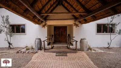 an entrance to a building with a wooden door at Zebula Golf and Wildlife Estate - Jackals Call Pax 8 - Moi Signature Luxury villa in Mabula