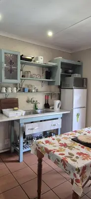 a kitchen with a sink and a refrigerator at Die Eend in Centurion