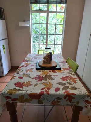 a table with a table cloth with leaves on it at Die Eend in Centurion