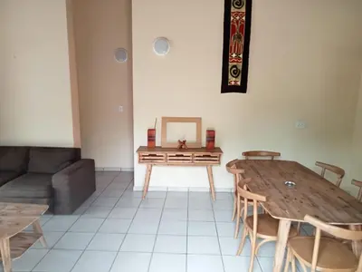 a living room with a table and a couch at Le Lion Dort in Marloth Park