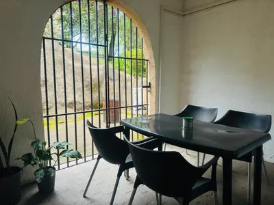 a table and chairs in a room with a window at Busa House in White River