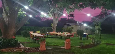 a garden at night with tables and lights at Blossom Retreat at Ilnika Farm Stay in Naboomspruit