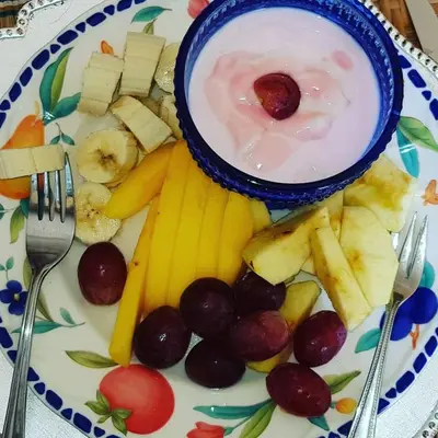 a plate of food with a bowl of yogurt and fruit at Blossom Retreat at Ilnika Farm Stay in Naboomspruit