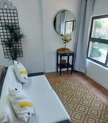 a bedroom with two white beds and a mirror at Blossom Retreat at Ilnika Farm Stay in Naboomspruit