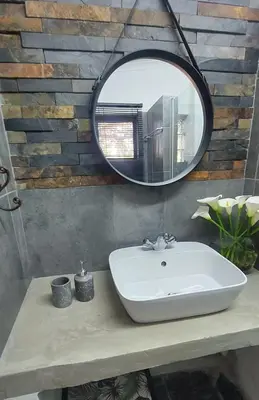 a bathroom with a sink and a mirror at Ilnika Farm Stay in Naboomspruit